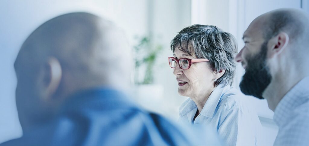 Business discussion among professionals, representing inclusive leadership initiatives.