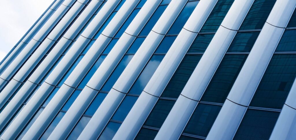 Modern office building facade representing the Head of Equities appointment in an asset management firm.