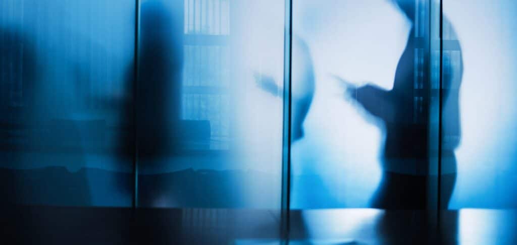 Silhouettes in an office meeting, illustrating financial leadership in a UK family office.