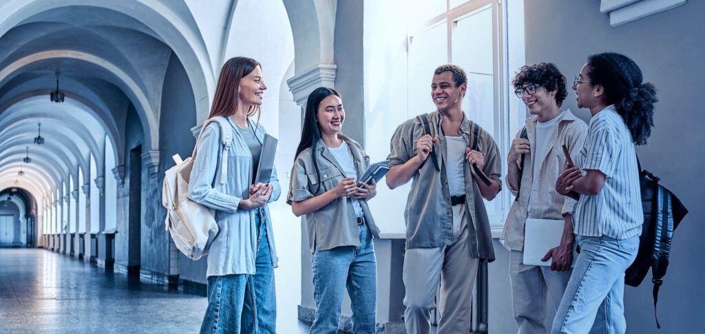 Group of university students walking through a hallway, representing digital leadership in higher education.