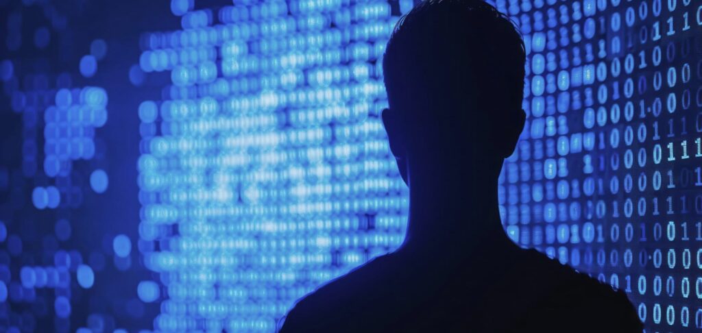 Silhouette of a person over digital code background, symbolising data protection and cyber security.