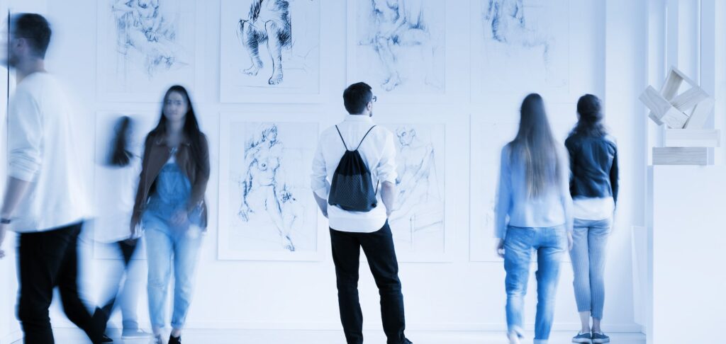 Visitors viewing artwork in a university museum, symbolising cultural leadership in higher education.