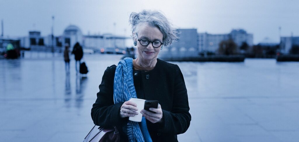 Professional outdoors reviewing documents, representing leadership in emerging market debt asset management.