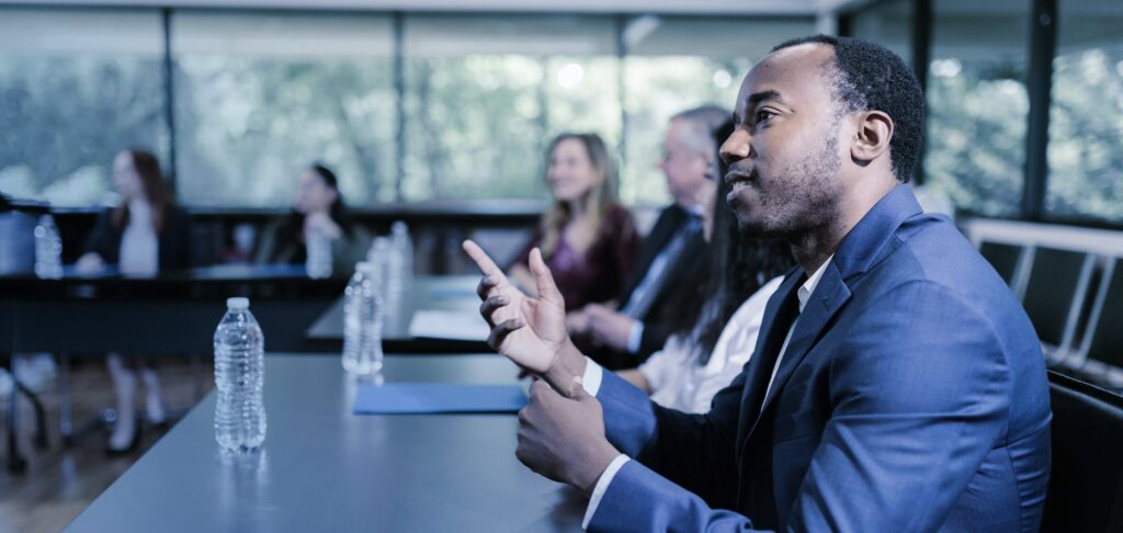 Business professional speaking at meeting, symbolising leadership and board diversity.