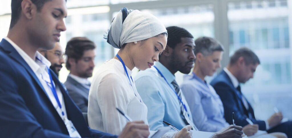 Diverse audience attending a conference, symbolising global talent competition.
