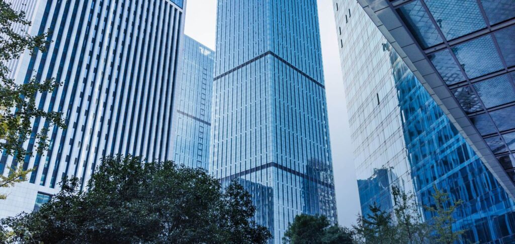 City high-rise buildings representing the Head of Asset Management UK role for a global real estate investor