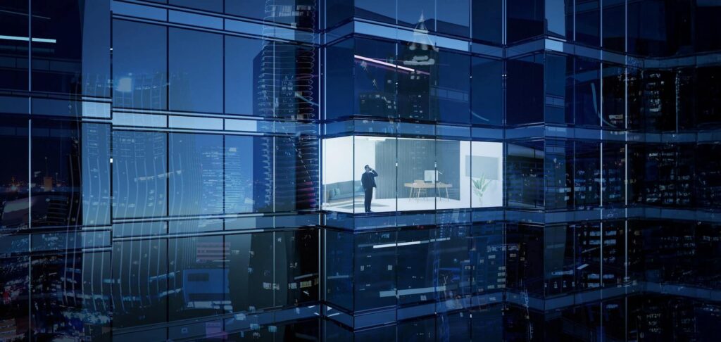 Modern glass office building at night, representing corporate finance leadership in Iberia.