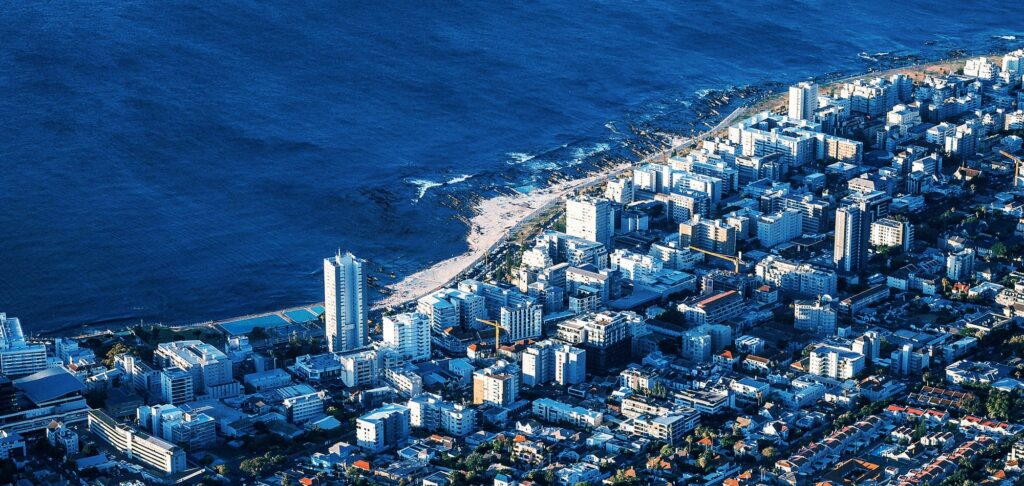 Aerial coastal view of South African city, representing global business insights.