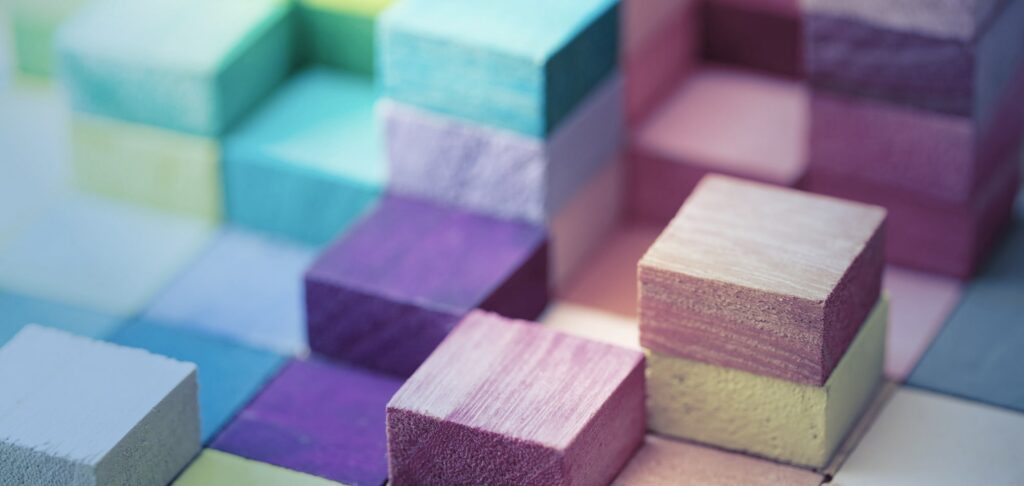 Stacked coloured cubes representing diverse frameworks and inclusion strategies.