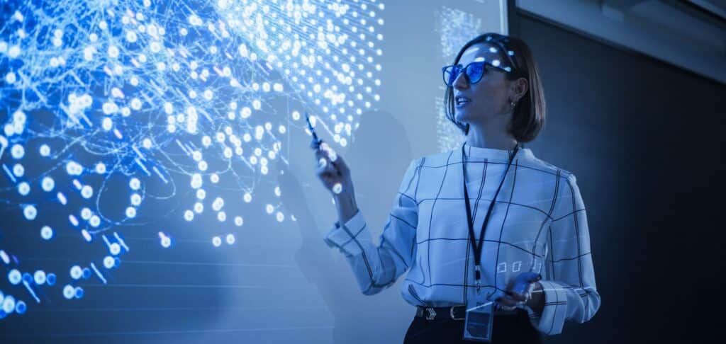 Businesswoman presenting data visualisation, symbolising strategic leadership and governance.