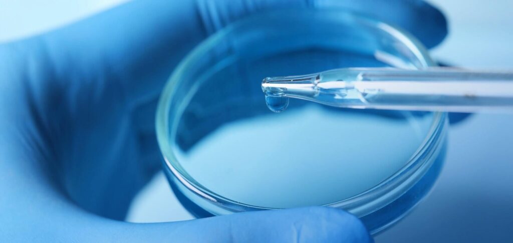 Scientist handling laboratory equipment representing the Interim CISO placement for a research institution.