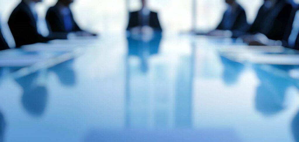 Boardroom meeting scene representing the Chair appointment at a UK listed asset manager